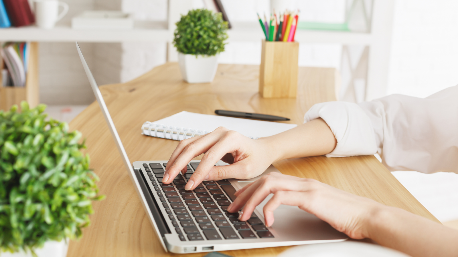 Female hands writing on a keyboard