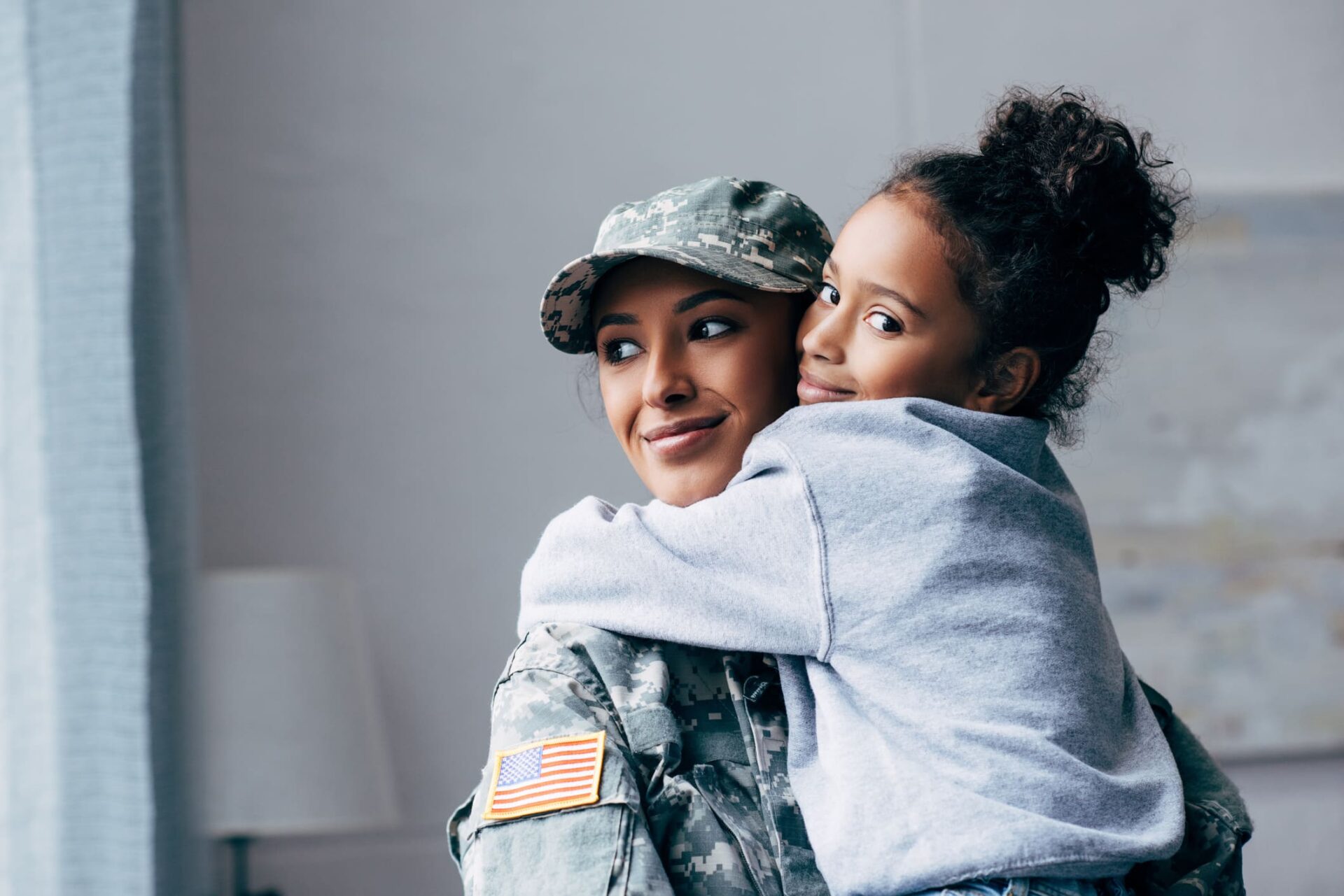 military woman hugging a girl