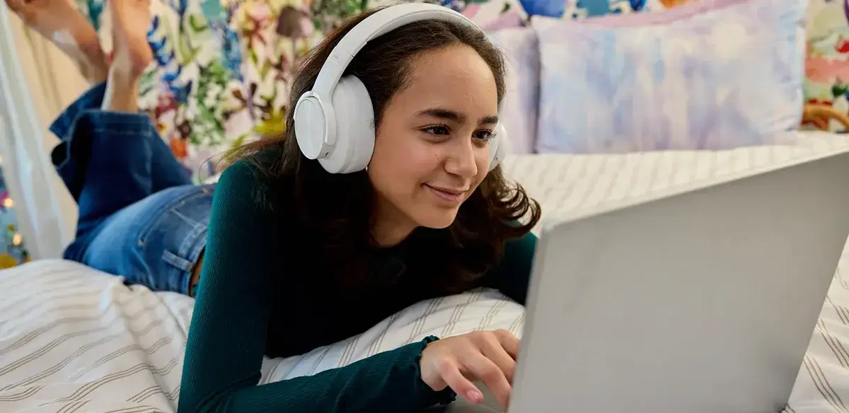 Student wearing a white pair of headphones