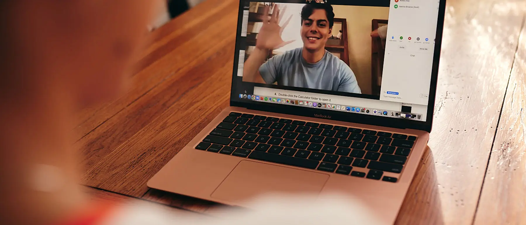 Student looking at another student on her computer screen